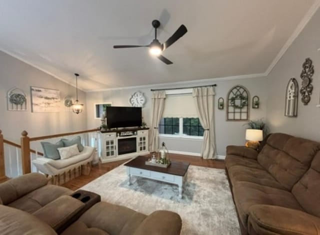 living room with ceiling fan, crown molding, vaulted ceiling, wood finished floors, and baseboards
