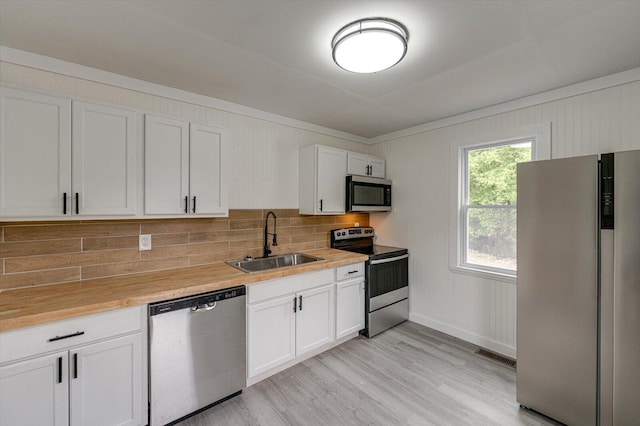 9 Longstreet Rd, Rossville, GA 30741 - kitchen with appliances with stainless steel finishes, a sink, tasteful backsplash, and white cabinets