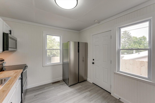 9 Longstreet Rd, Rossville, GA 30741 - kitchen with appliances with stainless steel finishes, butcher block countertops, light wood-style floors, white cabinetry, and baseboards