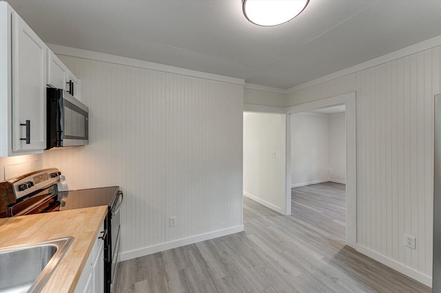 9 Longstreet Rd, Rossville, GA 30741 - kitchen featuring stainless steel appliances, light wood-style flooring, wooden counters, white cabinetry, and a sink