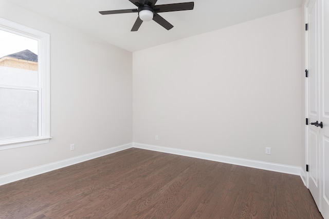 unfurnished room featuring a ceiling fan, dark wood-type flooring, baseboards, and plenty of natural light