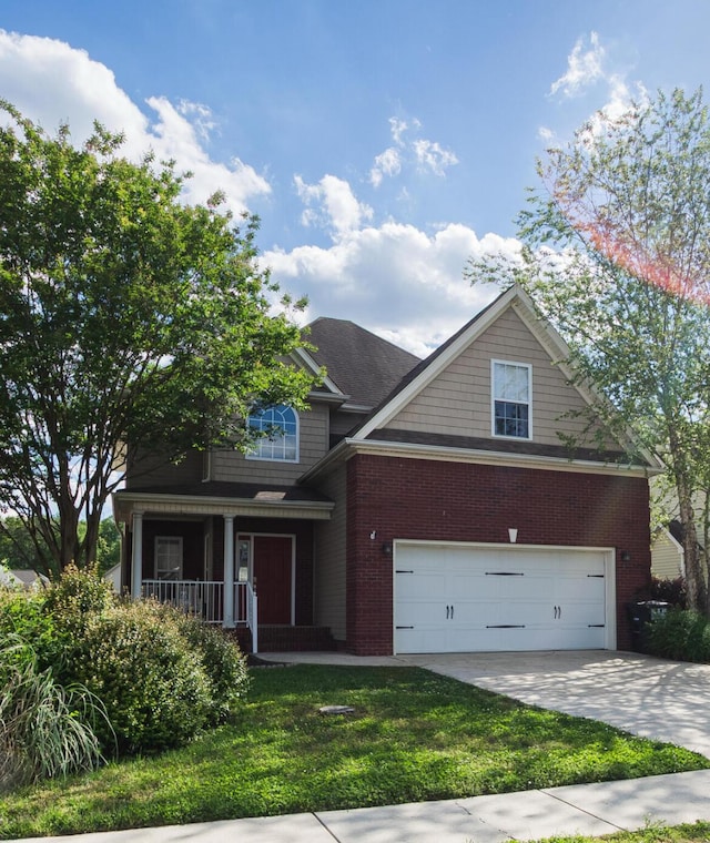 8420 Sophie Ln, Ooltewah, TN 37363 - traditional home featuring a porch, driveway, brick siding, a garage, and a front lawn