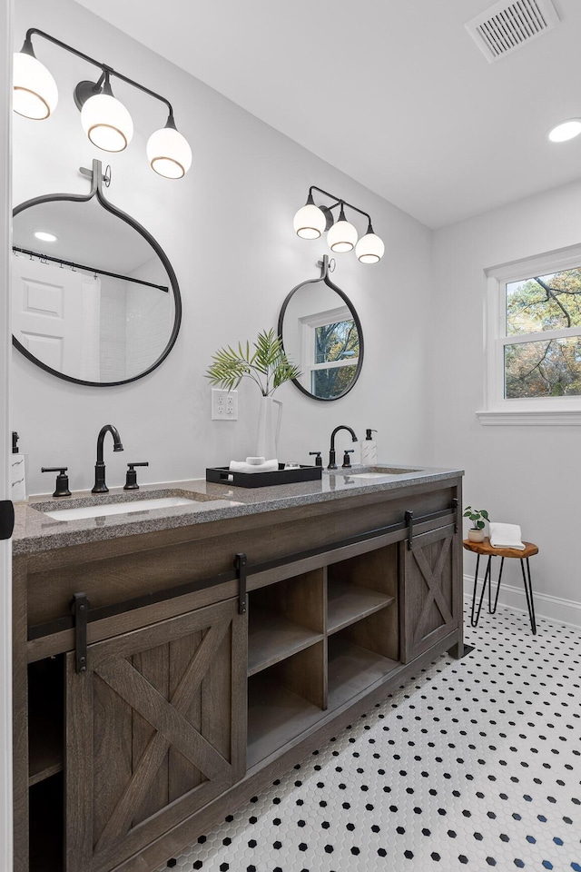 3235 Haywood Ave, Chattanooga, TN 37415 - full bath featuring double vanity, visible vents, baseboards, and a sink