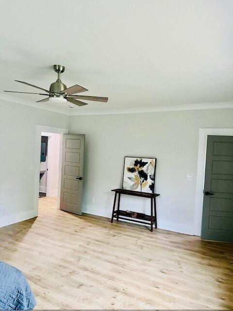 bedroom featuring ornamental molding, light wood-type flooring, baseboards, and a ceiling fan