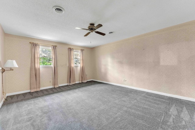 unfurnished room featuring baseboards, visible vents, ceiling fan, and carpet floors