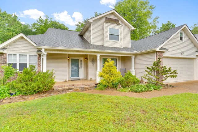 802 Creek Overlook Rd, Chattanooga, TN 37415 - traditional-style home with covered porch, roof with shingles, a garage, and a front yard