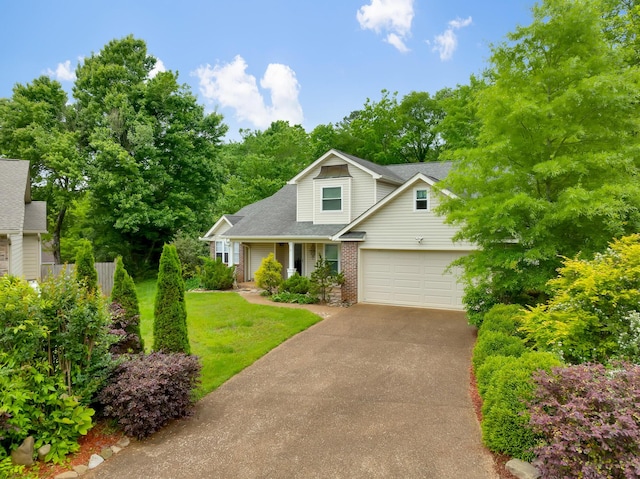 802 Creek Overlook Rd, Chattanooga, TN 37415 - view of front facade with driveway, brick siding, roof with shingles, a porch, and an attached garage