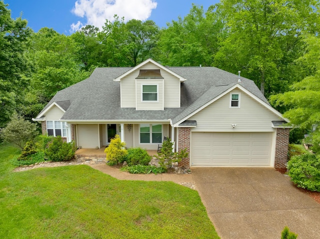802 Creek Overlook Rd, Chattanooga, TN 37415 - view of front of property with brick siding, a garage, concrete driveway, a shingled roof, and a front lawn