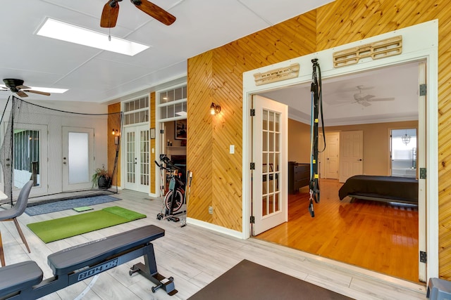 802 Creek Overlook Rd, Chattanooga, TN 37415 - exercise room with a ceiling fan, wooden walls, french doors, wood finished floors, and a skylight