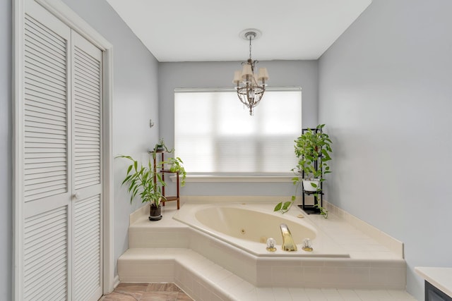802 Creek Overlook Rd, Chattanooga, TN 37415 - bathroom featuring a closet, a whirlpool tub, and a chandelier