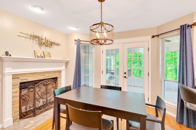 802 Creek Overlook Rd, Chattanooga, TN 37415 - dining room with a chandelier, light wood-style floors, french doors, a fireplace, and baseboards