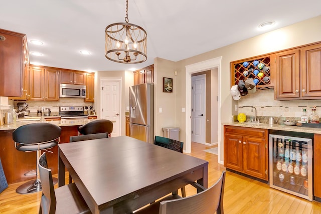 802 Creek Overlook Rd, Chattanooga, TN 37415 - dining area with wine cooler, bar, light wood-style floors, recessed lighting, and a chandelier