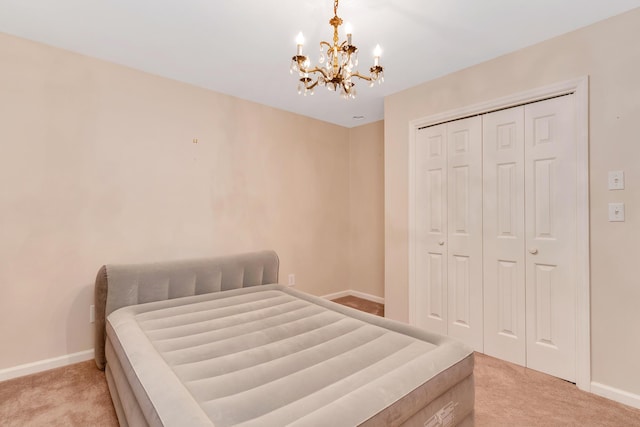 802 Creek Overlook Rd, Chattanooga, TN 37415 - bedroom with light carpet, a chandelier, baseboards, and a closet