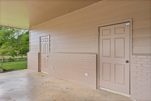 6904 Hickory View Ln, Chattanooga, TN 37421 - view of exterior entry featuring fence, brick siding, and a patio