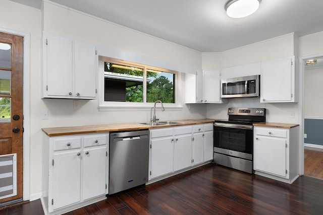 6904 Hickory View Ln, Chattanooga, TN 37421 - kitchen featuring appliances with stainless steel finishes, a sink, butcher block counters, dark wood-style flooring, and white cabinetry