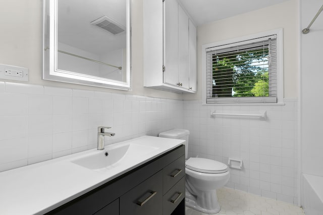 6904 Hickory View Ln, Chattanooga, TN 37421 - bathroom featuring toilet, tile walls, wainscoting, vanity, and tile patterned flooring