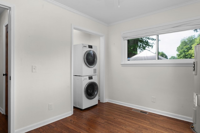 6904 Hickory View Ln, Chattanooga, TN 37421 - clothes washing area with stacked washing machine and dryer, crown molding, baseboards, and dark wood-style floors