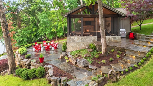 exterior space with a warm lit fireplace