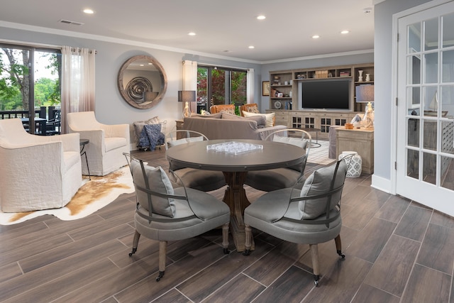 dining area featuring crown molding, a wealth of natural light, and recessed lighting