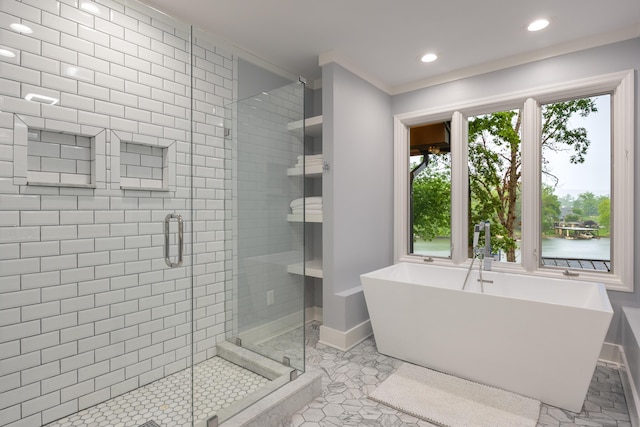 full bath with baseboards, recessed lighting, a freestanding bath, and a stall shower