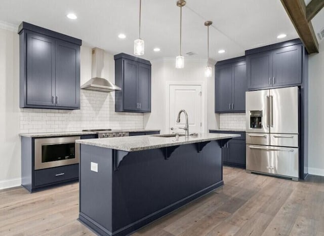 134 River Ridge Drive Unit 117, Dunlap, TN 37327 - kitchen with appliances with stainless steel finishes, wall chimney range hood, a sink, light stone counters, and a kitchen breakfast bar