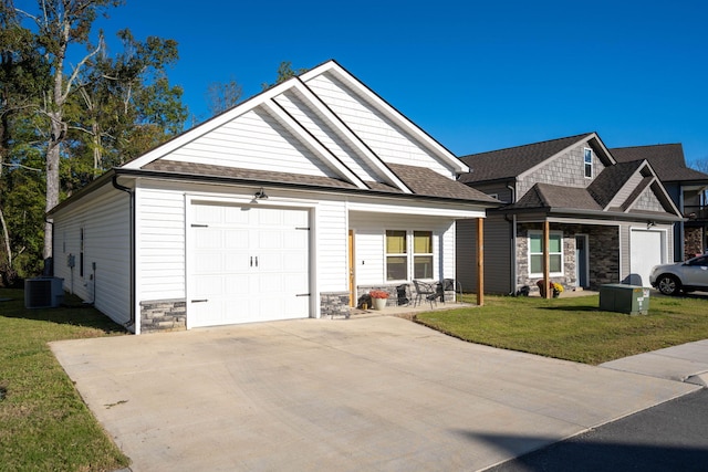 68 Rock Bridge Dr, Ringgold, GA 30736 - view of front of house with stone siding, central AC unit, a garage, a front lawn, and driveway