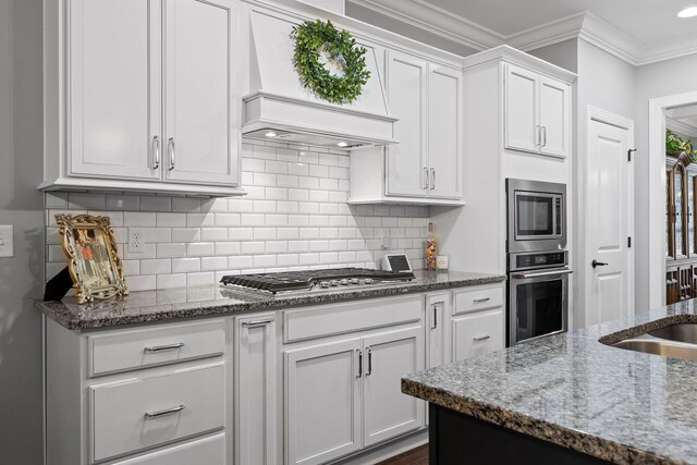 7258 Grey Hawk Trl, Signal Mountain, TN 37377 - kitchen featuring stainless steel appliances, premium range hood, white cabinetry, dark stone countertops, and backsplash