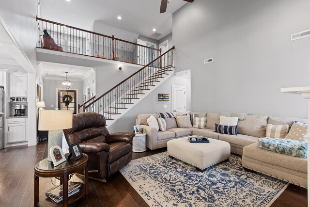 7258 Grey Hawk Trl, Signal Mountain, TN 37377 - living room featuring a towering ceiling, stairway, dark wood-style flooring, ceiling fan, and ornamental molding