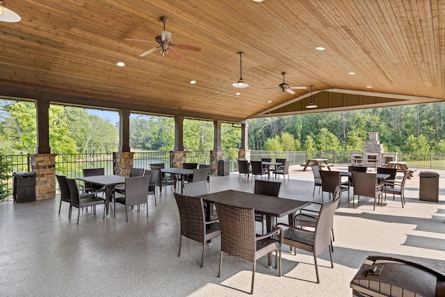 7258 Grey Hawk Trl, Signal Mountain, TN 37377 - view of patio with outdoor dining space, an outdoor stone fireplace, a ceiling fan, and view of wooded area