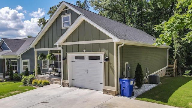 1105 18th St NW, Cleveland, TN 37311 - view of front facade with board and batten siding, roof with shingles, a front lawn, and central AC unit