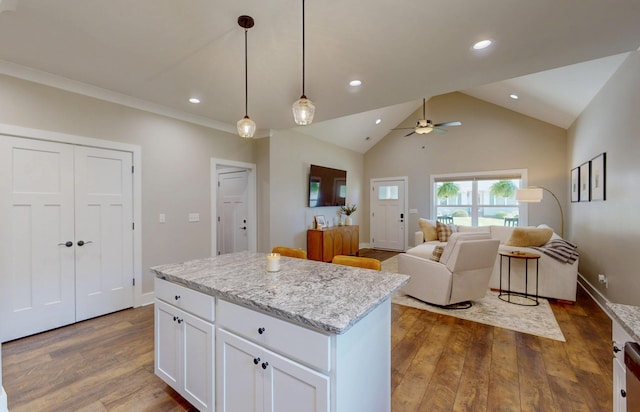 1105 18th St NW, Cleveland, TN 37311 - kitchen featuring ceiling fan, dark wood-style flooring, a kitchen island, white cabinetry, and decorative light fixtures