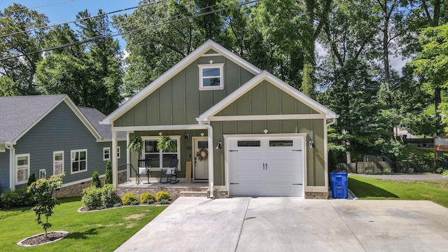 1105 18th St NW, Cleveland, TN 37311 - view of front facade with covered porch, board and batten siding, a front lawn, and driveway