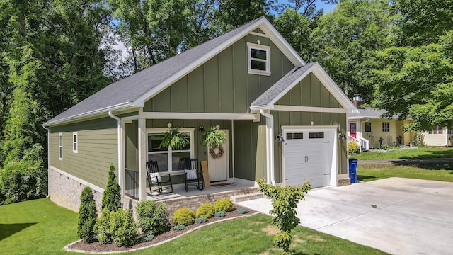 1105 18th St NW, Cleveland, TN 37311 - view of front facade featuring a porch, board and batten siding, a front lawn, a garage, and concrete driveway
