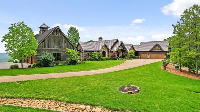 6835 Jasper Highlands Blvd, Jasper, TN 37347 - view of front facade with a standing seam roof, a front lawn, concrete driveway, metal roof, and a chimney