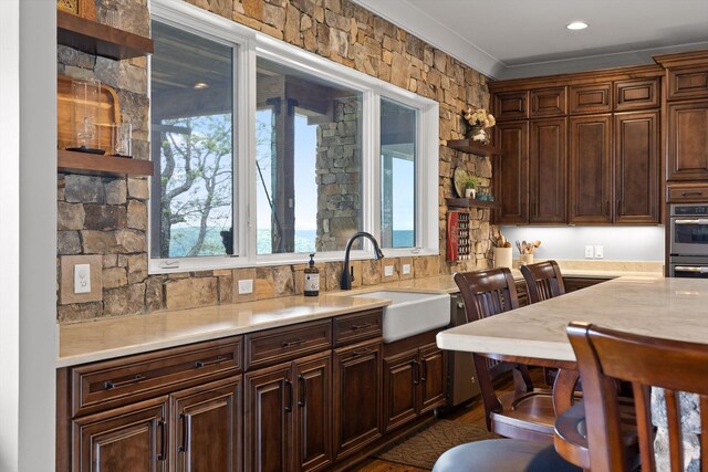 6835 Jasper Highlands Blvd, Jasper, TN 37347 - kitchen with a sink, light countertops, stainless steel double oven, ornamental molding, and open shelves