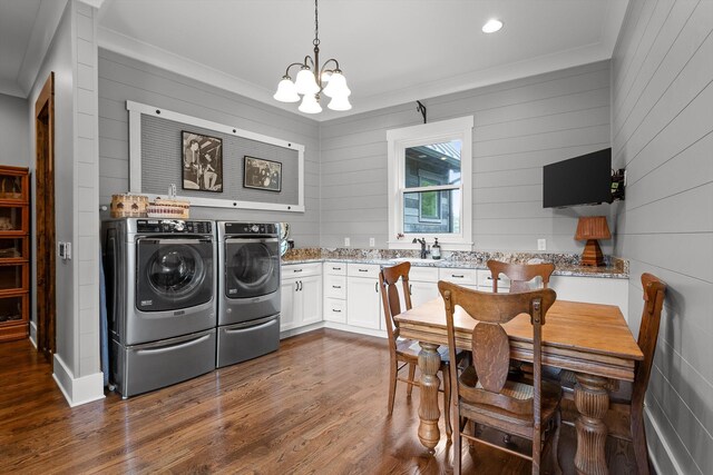 6835 Jasper Highlands Blvd, Jasper, TN 37347 - laundry area with washing machine and dryer, a chandelier, crown molding, dark wood-style floors, and wood walls