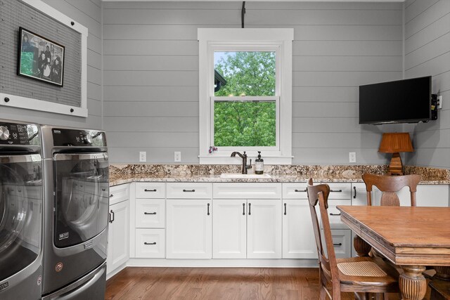 6835 Jasper Highlands Blvd, Jasper, TN 37347 - laundry area featuring washer and clothes dryer, cabinet space, wood finished floors, and wood walls