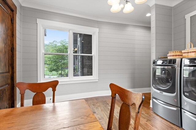 6835 Jasper Highlands Blvd, Jasper, TN 37347 - laundry room with washer and dryer, wood finished floors, a chandelier, wood walls, and baseboards