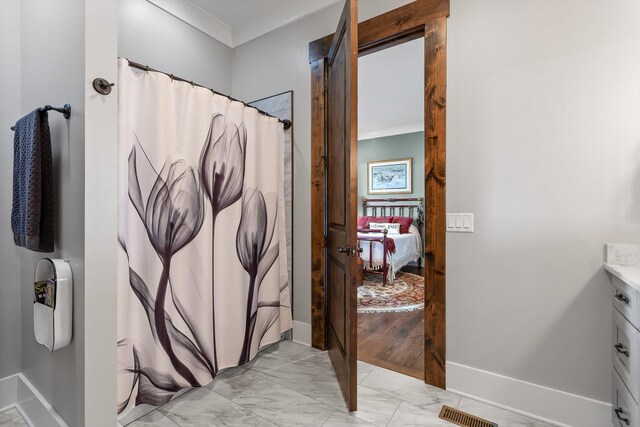 6835 Jasper Highlands Blvd, Jasper, TN 37347 - ensuite bathroom featuring marble look tile flooring, ornamental molding, baseboards, vanity, and a shower with shower curtain