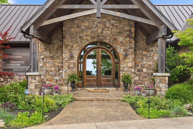 6835 Jasper Highlands Blvd, Jasper, TN 37347 - doorway to property featuring french doors, a standing seam roof, stone siding, and metal roof