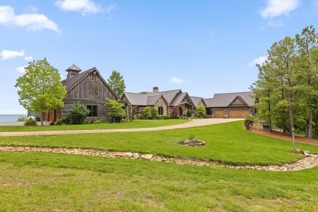 6835 Jasper Highlands Blvd, Jasper, TN 37347 - view of front facade featuring driveway, a front yard, a standing seam roof, metal roof, and a chimney