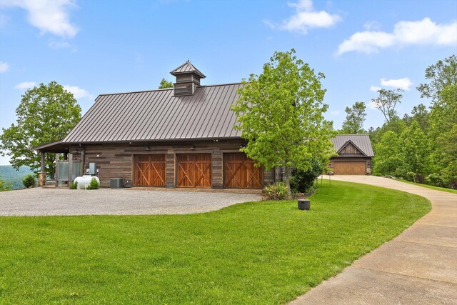 6835 Jasper Highlands Blvd, Jasper, TN 37347 - view of front of property with a front yard, central AC, metal roof, and a standing seam roof