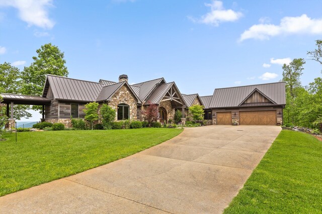 6835 Jasper Highlands Blvd, Jasper, TN 37347 - view of front of home with a standing seam roof, stone siding, a chimney, driveway, and an attached garage