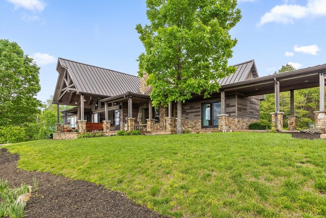 6835 Jasper Highlands Blvd, Jasper, TN 37347 - rear view of property with a standing seam roof, a yard, metal roof, and stone siding