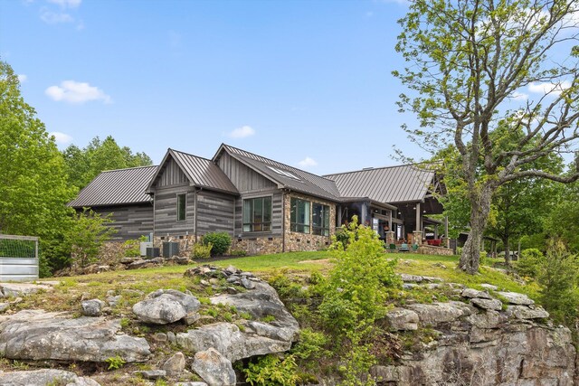 6835 Jasper Highlands Blvd, Jasper, TN 37347 - view of property exterior featuring metal roof, a standing seam roof, central air condition unit, and stone siding