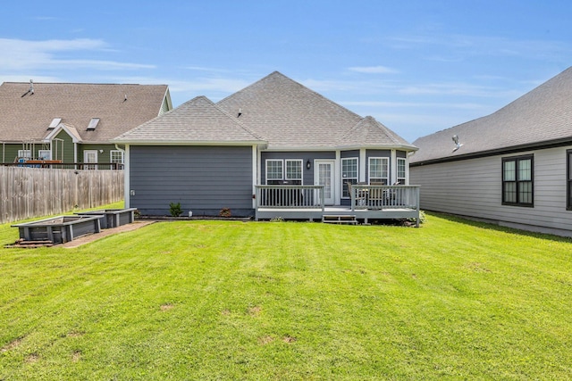 7861 Laurelton Dr, Chattanooga, TN 37421 - back of house featuring a deck, roof with shingles, and a vegetable garden
