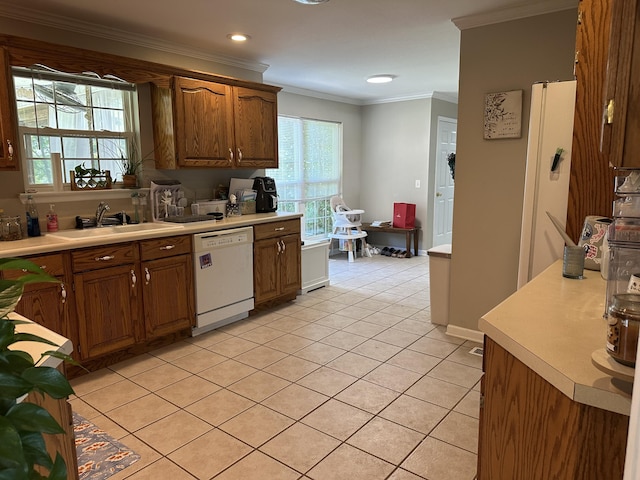 kitchen with a sink, dishwasher, light countertops, light tile patterned floors, and ornamental molding