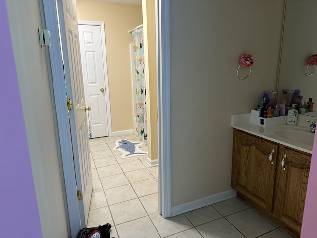 full bath featuring tile patterned flooring, vanity, a shower with shower curtain, and baseboards