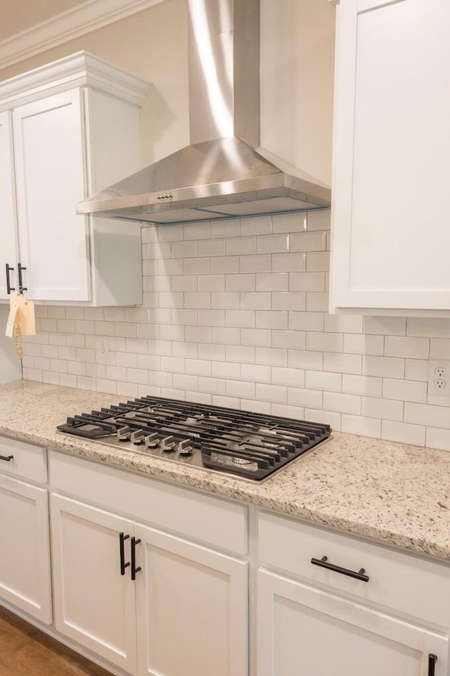 8880 Knolling Loop Unit 35, Ooltewah, TN 37363 - kitchen featuring wall chimney range hood, stainless steel gas stovetop, white cabinets, decorative backsplash, and crown molding