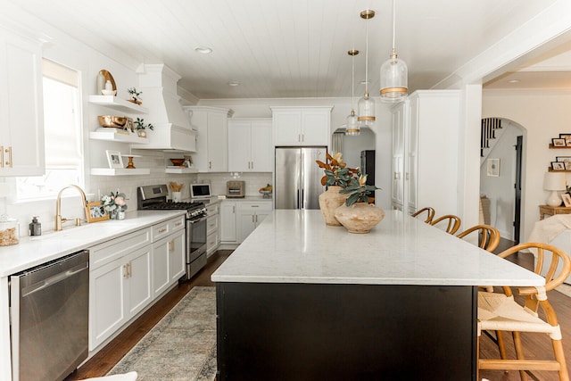 9405 Peppy Branch Trl, Apison, TN 37302 - kitchen featuring appliances with stainless steel finishes, a sink, arched walkways, a kitchen breakfast bar, and custom exhaust hood